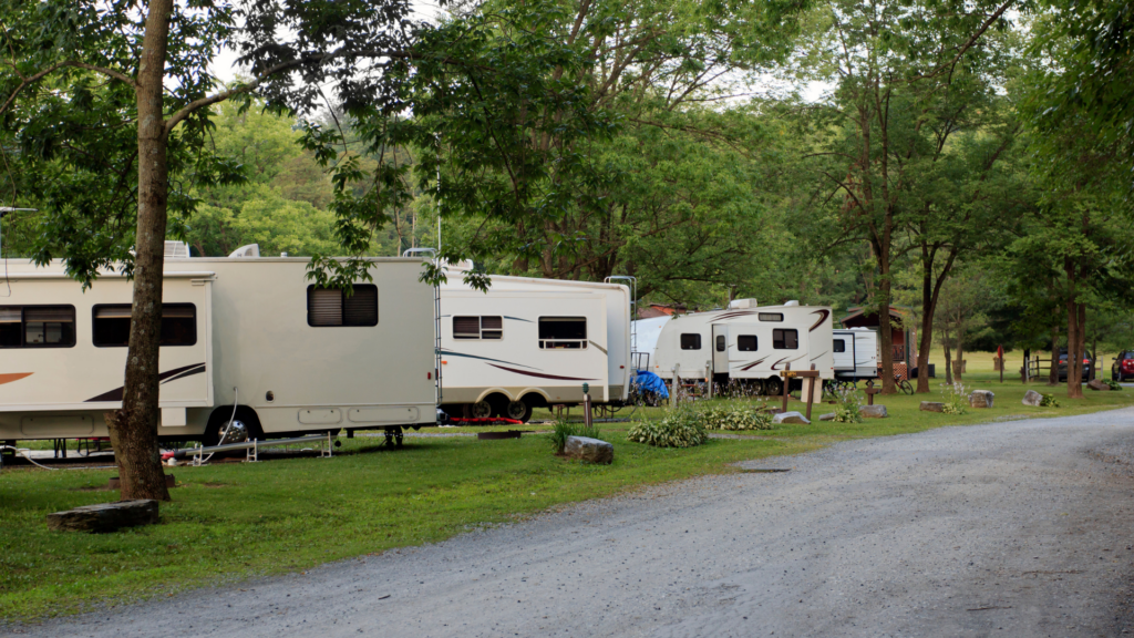 An RV park with a row of RVs. Nightly cost is something you need to factor in to your full-time RV budget
