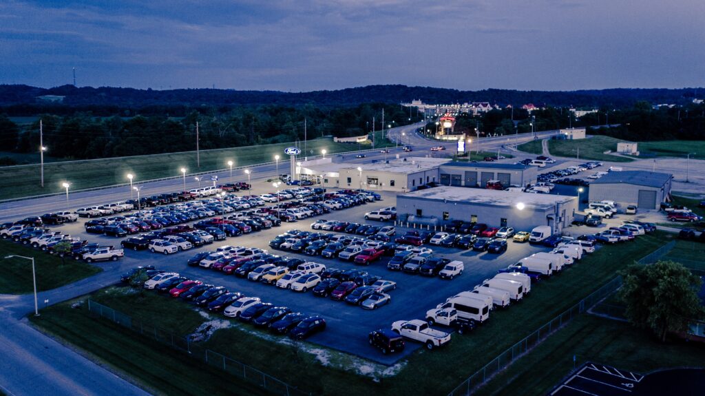 A dealership at night from above. 